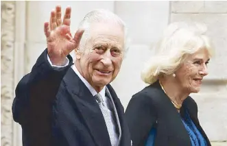  ?? AFP ?? King Charles and Queen Camilla greet their supporters as they leave a clinic in London on Jan. 29.