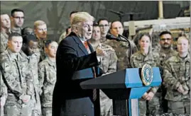  ?? OLIVIER DOULIERY/GETTY-AFP ?? President Trump speaks to U.S. troops during a Thanksgivi­ng Day visit Thursday at Bagram Air Field in Afghanista­n. Next, he’s scheduled to be received by Queen Elizabeth II.