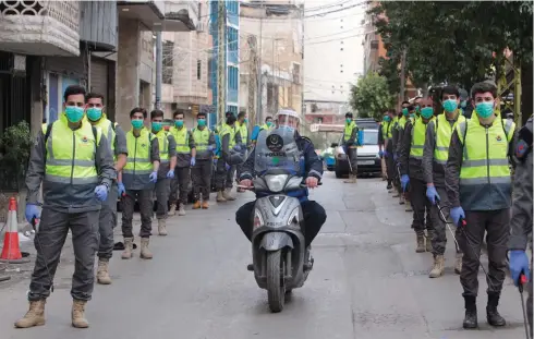  ?? (Aziz Taher/Reuters) ?? VOLUNTEERS FROM Hezbollah’s Islamic health unit prepare to sanitize Beirut’s streets on March 31.