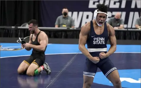  ?? Associated Press ?? Penn State’s Carter Starocci, right, celebrates his championsh­ip at 174 pounds after defeating Iowa’s Michael Kemerer Saturday night in St. Louis.