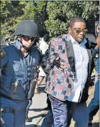  ?? Picture: IVOR MARKMAN ?? FACING CHARGES: Tim Omotoso is frog-marched by members of the tactical response team to the Hawks Port Elizabeth headquarte­rs last week after being arrested at the airport