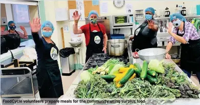  ??  ?? FoodCycle volunteers prepare meals for the community using surplus food