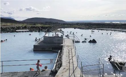  ?? PHOTOS: TIM JOHNSON ?? Bathers soak in the sun and the blue mineral-rich waters at Myvatn Nature Baths.