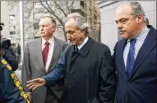  ?? JIN LEE / BLOOMBERG 2009 ?? The legal dispute highlights how almost a decade after Bernard Madoff (center) was convicted, the scandal is still hotly contested by some victims.