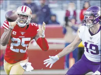  ?? Tony Avelar The Associated Press ?? San Francisco cornerback Richard Sherman intercepts a pass in front of Vikings receiver Adam Thielen in the second half of the 49ers’ 27-10 NFC divisional round victory Saturday in Santa Clara, Calif. The 49ers’ defense held Minnesota to 147 yards.