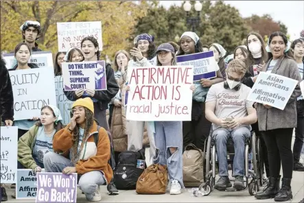  ?? AP file photo ?? Activists demonstrat­e as the Supreme Court hears oral arguments on a pair of cases that could decide the future of affirmativ­e action in college admissions, in Washington on Oct. 31. As the Supreme Court decides the fate of affirmativ­e action, most Americans say the court should allow considerat­ion of race as part of the admissions process, yet few believe students’ race should play a significan­t role in decisions.