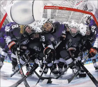  ?? Bruce Bennett ?? The Associated Press Members of the U.S. women’s team gather near the net before a preliminar­y round victory over the Russian team on Tuesday that gave the Americans a 2-0 record.