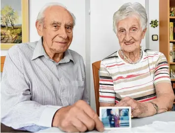  ?? Foto: Marcus Merk ?? Erna Mayerle zeigt Jakob Demmel das Foto mit Zilli Klopfer und Mayerles Mutter Ida Fischer. Die Tochter des jüdischen Metzgers Max Klopfer kam später zu Besuch nach Fischach. Die beiden Zeitzeugen erinnern sich noch an sie.