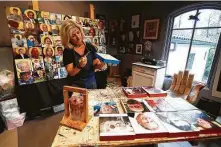  ??  ?? Joni Zavitsanos paints a frame as she works on her COVID-19 memorial project of hand-painted and collaged plaques.