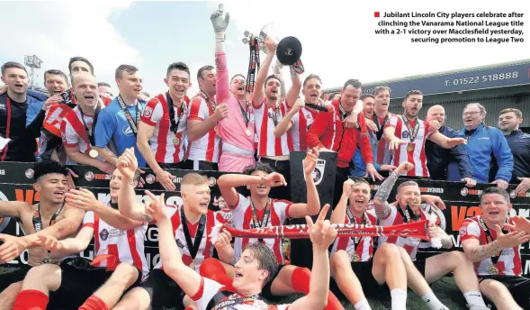  ??  ?? Jubilant Lincoln City players celebrate after clinching the Vanarama National League title with a 2-1 victory over Macclesfie­ld yesterday, securing promotion to League Two