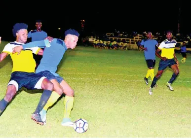  ?? FILE ?? Tevoy Colespring (second left) of Meadforest FC holds off Barbican FC’s Damian English during their Magnum KSAFA Super League first-round clash at the Constant Spring Complex last season.