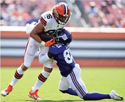  ?? DAVID DERMER/AP ?? Browns tight end Connor Davis is tackled by the Giants’ Matt Cole during the second half of a preseason game Aug. 22 in Cleveland.