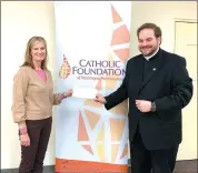  ?? Photo submitted ?? Lisa Louis, Catholic Foundation of Northwest Pennsylvan­ia executive director, presents a grant check to Father Justin Pino of Saint Leo Magnus Parish.