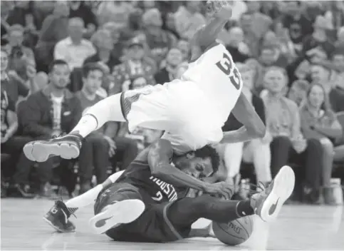  ?? —AP ?? OAKLAND: Golden State Warriors’ Kevin Durant (35) falls onto Houston Rockets’ Patrick Beverley during the second half of an NBA basketball game Thursday, in Oakland, Calif. Houston won 132-127 in double overtime.