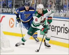  ?? Tom Gannam / Associated Press ?? Minnesota’s Luke Johnson, right, controls the puck as he is pursued by St. Louis’ Sammy Blais on Thursday.