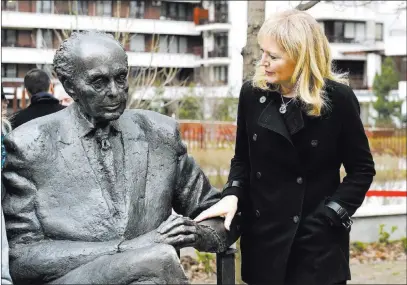  ?? Noemi Bruzak ?? The Associated Press Katrina Lantos Swett touches the statue of her father, late Hungarian-born U.S. Rep. Tom Lantos, during the unveiling ceremony Thursday near Lantos’ former school — Berzsenyi Daniel Secondary School — in Budapest, Hungary.