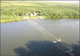  ??  ?? FLOATING WEIR—In high water situations, the floating weirs’ panels will sink under the water. Once the water flow slows and the water level drops, the panels start to rise and “float” the weir back up.As of last week Wednesday, the Pilgrim weir is again operationa­l