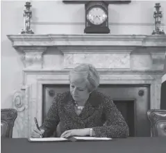  ?? AFP ?? Prime Minister Theresa May signs the official letter to European Council President Donald Tusk, signaling the United Kingdom’s intention to leave the EU.