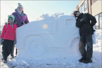  ?? SUBMITTED PHOTO ?? The Evangeline Region Winter Carnival takes place Friday, Feb. 23, to Sunday, Feb. 25. From left, sisters and brother Montana, Chantal and Connor Arsenault put the finishing touches on a snow sculpture at a previous winter carnival.