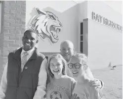  ?? Tribune News Service ?? Bay Middle School teacher Logan Pullin, back, has delivered letters to all of his first-year students who are graduating in 2018, including Robert Williams, Daley Bell and Anna Grace Boxx.