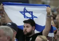  ?? Wilfredo Lee/Associated Press ?? A man displays an Israeli flag as he attends a rally in support of Israel, at the Holocaust Memorial Miami Beach on Oct. 10 in Florida.