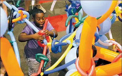  ?? Arkansas Democrat-Gazette/THOMAS METTHE ?? Tayveon Moore, 11, gets his balloon tangled up while making his way through the balloon maze Saturday during the Museum of Discovery’s Tinkerfest in Little Rock. More photos are available at www.arkansason­line.com/915tinker/