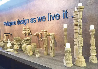  ??  ?? Free-form stone bowls from L’Auras y Levi and carved wooden bulols, santos and candlestic­ks from Chanalli showcase our rich Philippine arts and culture.