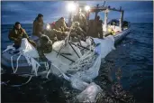  ?? U.S. NAVY VIA AP ?? Navy sailors assigned to Explosive Ordnance Disposal Group 2recover a high-altitude surveillan­ce balloon off the coast of Myrtle Beach, S.C., on Sunday.