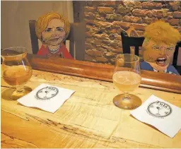  ?? BY JOHN MCCASLIN ?? Hillary Clinton and Donald Trump dolls, which for six months swayed in the mountain breezes above the bar at Tula’s, finally sat together for a drink this week.