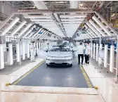  ?? KEITH BRADSHER/THE NEW YORK TIMES ?? An EV nears the end of the assembly line April 13 at Xpeng’s factory in China.