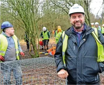  ?? ?? JOINING FORCES: DIY SOS presenter Nick Knowles and the team hard at work in Fegg Hayes.