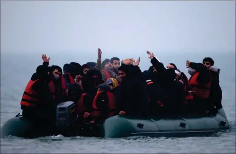  ?? Picture: Gonzalo Fuentes ?? A group of more than 40 migrants leaves the coast of northern France, near Wimereux, to cross the English Channel yesterday