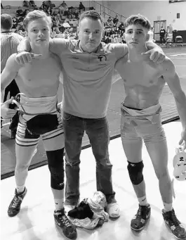  ?? COURTESY PHOTO ?? Wrestling brothers Aiden Poe, left, and Joseph Lyttle are pictured with their father, Clint Lyttle. The boys live in different homes but train together and have advanced to state.