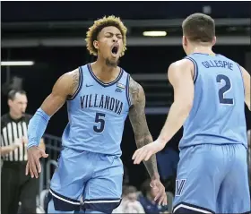  ?? DARRON CUMMINGS — THE ASSOCIATED PRESS ?? Villanova’s Justin Moore (5) reacts with Collin Gillespie (2) during the first half of an NCAA college basketball game against Butler, Saturday.