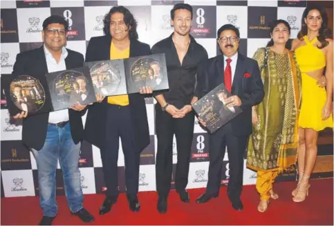  ??  ?? Tiger Shroff with Mr. Amar Sinha (3rd from right), COO of Radico Khaitan unveils 8 PM Premium Black’s Music CD