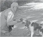  ?? PAUL A. SMITH ?? Gary Zimmer of Rhinelande­r gives his dog Scout a drink of water during a hunt for ruffed grouse and woodcock near Rhinelande­r.