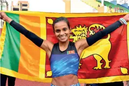  ??  ?? Hiruni Wijayaratn­e proudly holds the Lion flag at the 13th SAG in Nepal