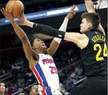  ?? AP photo ?? Jazz center Walker Kessler tons guard Jaden Ivey during the first half of Utah’s 119-111 win over Detroit on Thursday.