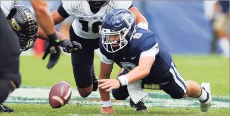  ?? Stew Milne / Associated Press ?? UConn quarterbac­k Steven Krajewski (8) looks to recover a fumble during the first half against Purdue on Saturday in East Hartford.