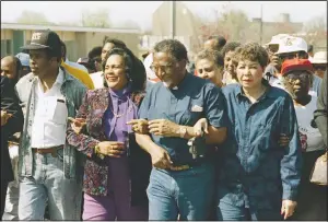  ?? (File Photo/AP/Dave Martin) ?? Coretta Scott King walks in March 1990 arm-in-arm with Southern Christian Leadership Conference President Joseph Lowery (second from right) in Selma, Ala., as marchers begin the final leg of their trek to the Alabama Capitol.