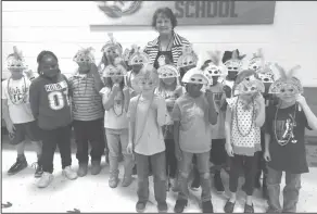  ??  ?? Mardi Gras: Junction City kindergart­ners learned a little Louisiana history about Mardi Gras. Tina Burroughs’ class is pictured with principal Teresa Matochik.