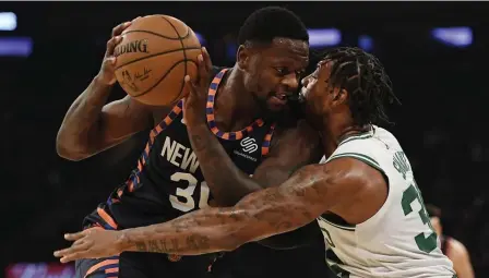  ?? AP ?? ‘PRETTY TENDER’: Celtics guard Marcus Smart defends New York Knicks forward Julius Randle on Sunday. Smart left the game early with an oblique injury.