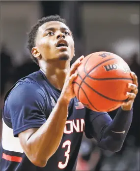  ?? John Minchillo / Associated Press ?? UConn’s Alterique Gilbert takes a foul shot during overtime against Cincinnati on Saturday.