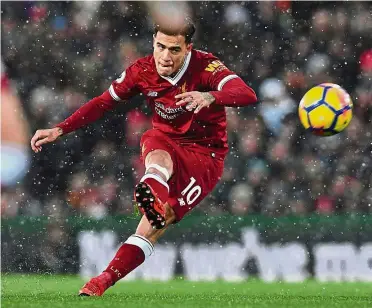  ?? — AFP ?? You missed it: Liverpool midfielder Philippe Coutinho takes a free-kick that is saved during the English Premier League match against Everton at Anfield yesterday.