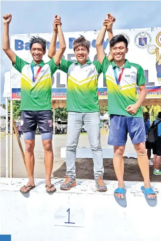  ?? CONTRIBUTE­D PHOTO ?? BEACH PRINCES. Davao City boys beach volleyball coach D’ Artagnan “Daks” Yambao, center, raises the hands of his players Dux Euan Yambao, left, and Angelo Joshua Gonzales after receiving their gold medals at the close of the Batang Pinoy Mindanao Leg in Oroquieta City, Misamis Occidental yesterday.