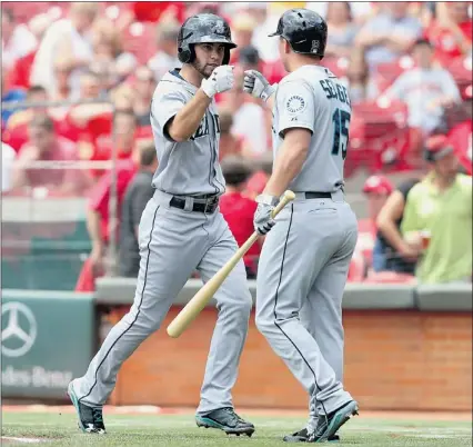  ?? — GETTY IMAGES ?? Mariners teammates Nick Franklin, left, and Kyle Seager celebrate after Franklin’s home run on Sunday against the Reds at Great American Ball Park in Cincinnati. The Mariners won 3-1.