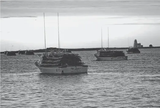  ?? SALTWIRE NETWORK FILE PHOTO ?? The sun rises to meet Prince Edward Island spring lobster fishermen as they head out of port on setting day in this file photo.