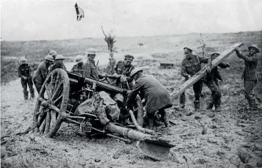  ??  ?? Soldiers battle to unearth a field gun from the mud at Passchenda­ele.