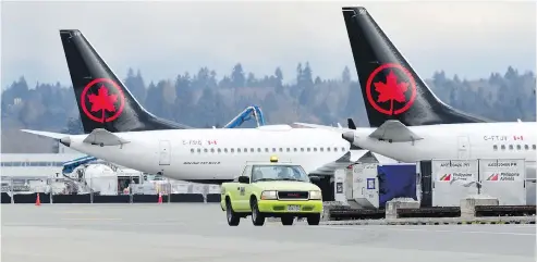  ?? NICK PROCAYLO / POSTMEDIA NEWS ?? Air Canada Boeing 737 Max 8 planes sit idle at Vancouver Internatio­nal on Wednesday as Canada and the U.S. follow other nations and ground the aircraft following the weekend crash of a Max 8 in Ethiopia that killed 157 people. A Max 8 crash five months ago in Indonesia killed all 189 aboard.