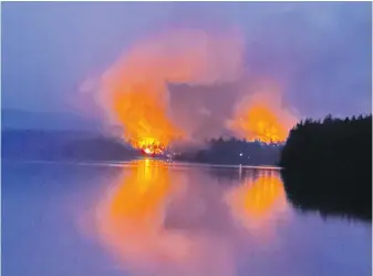  ?? MIKE COATES VIA CP ?? A wildfire burns near Centennial Lake, about 150 kilometres west of Ottawa, on Sunday. It was one of 21 new fire starts in Ontario on the weekend.